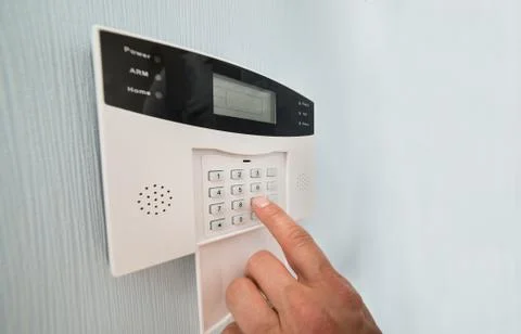 Close-up Of A Person's Hand Entering Code In Security System Stock Photos