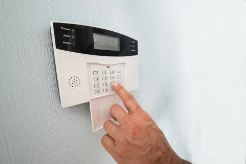Close-up Of A Person's Hand Entering Code In Security System Stock Photos