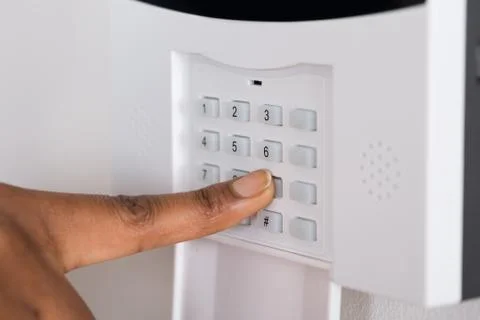 Close-up Of A Person's Hand Entering Code In Security System Stock Photos