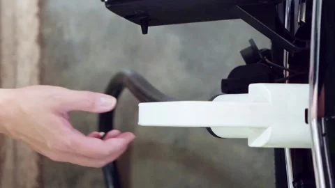 Close-up of a persons hand holding and unplugging an electric vehicle charger 動画素材 314770735