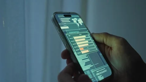 Close up on person's hand holding mobile phone with data transfer window Stock Footage 340427582