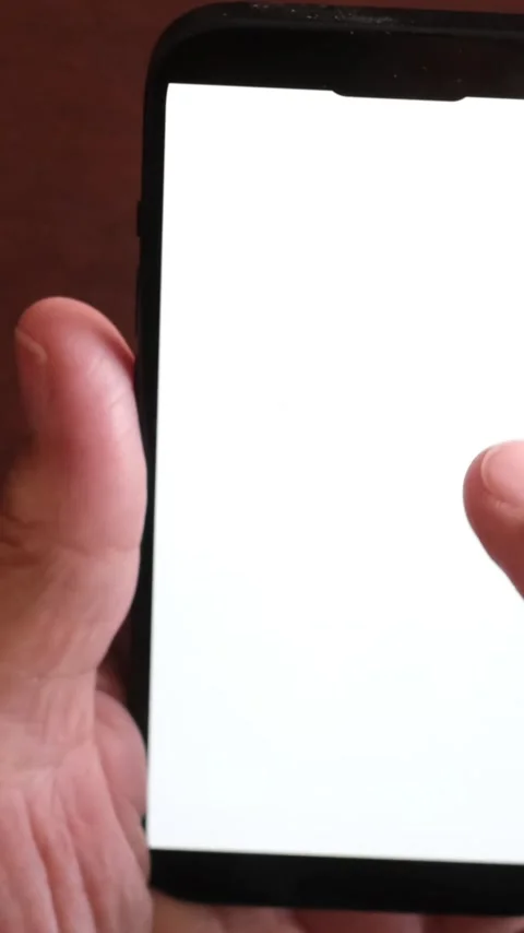 Close-up of a person's hand holding a modern smartphone and using a finger Stock Footage 344389675