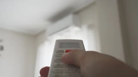 Close-up of a person's hand holding a remote control and pressing the red p.. Stock Footage 342762469