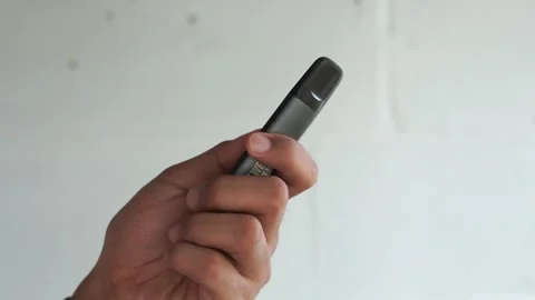 Close up of a person's hand holding vape electric cigarette. Stock Footage 327206422