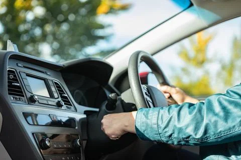 Close-up Of Person's Hand Inserting Key To Start Car. Woman's hand starts a.. Foto stock