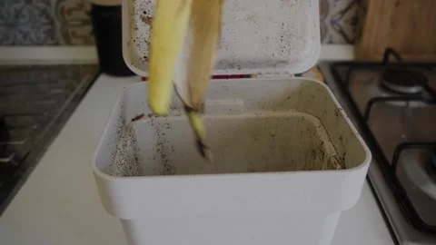 Close-up of a person's hand opening and closing a kitchen compost bin showing Video stock 342761033