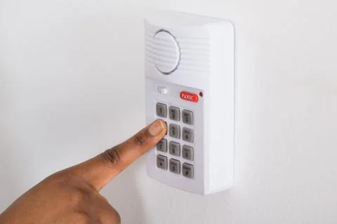 Close-up Of Person's Hand Pressing Button On Security System Foto stock