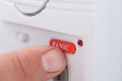 Close-up Of Person's Hand Pressing Panic Button Foto stock