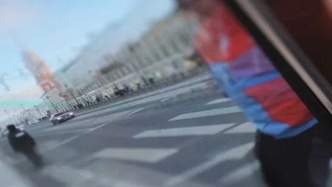 Close-up of a person's hand scrolling through an iPhone screen and selecting the Stock Footage 229958332