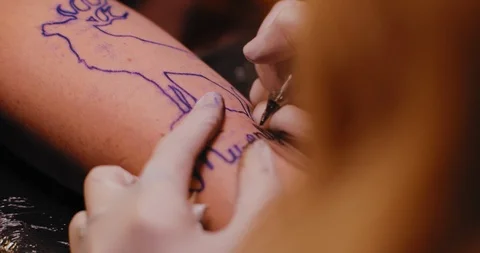 Close up of a person's hand with a tattoo being made by professional tattoois Stock Footage 125764798