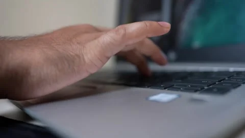 Close-up of a person's hand typing on a laptop keyboard Stock Footage 317131679