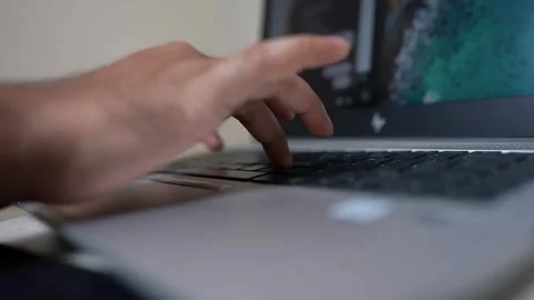 Close-up of a person's hand typing on a laptop keyboard Stock Footage 317131689