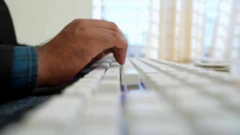 Close-up of a person's hand typing on a white keyboard Stock Footage 318057127