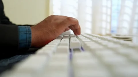 Close-up of a person's hand typing on a white keyboard Stock Footage 320725818