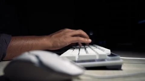 Close-up of a persons hand typing on a white keyboard at a desk with a blur.. Stock Footage 334285764