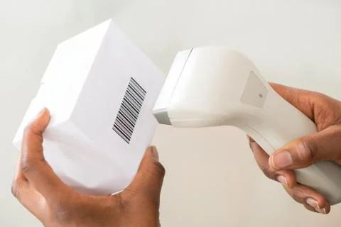 Close-up Of Person's Hand Using Barcode Scanner To Scan A Barcode On Product Stock-Fotos