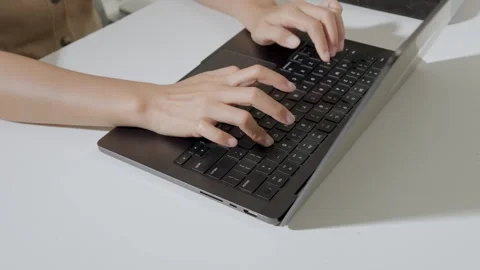Close up of a person's hand is working using laptop to type report or documen Stock Footage 338432945