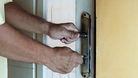 Close-up of a person’s hands closing and locking a door Stock Footage 320443373