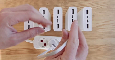 Close-up, a person's hands connect power banks to an outlet, charging power bank 動画素材 226809993