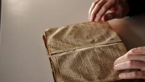 Close-Up of a Persons Hands Opening and Turning the Pages of an Old Book. Man Stock Footage 262640260
