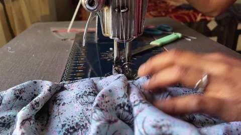 Close-up of a person's hands operating a vintage sewing machine Видео 328807751