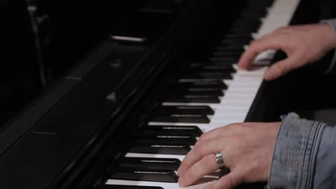 A close-up of a person's hands playing the piano live on stage Stock Footage 319480072