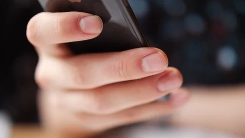 Close up of persons hands putting smart phone away Stock Footage 90512876