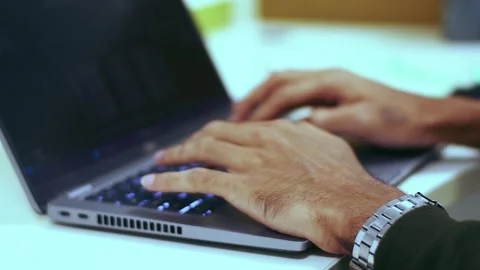Close-up of a person's hands rapidly typing on a backlit laptop keyboard, s.. Stock Footage 341353762