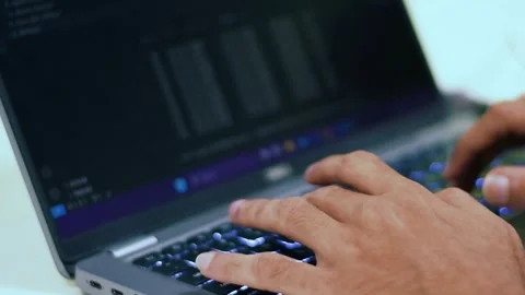 Close-up of a person's hands rapidly typing on a laptop keyboard with glowi.. Stock Footage 341353866