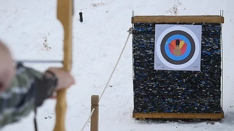 Close up of a person's hands shooting an arrow into a target. Stock Footage 100649138