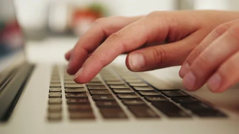 Close up of a person's hands typing on a laptop keyboard, indoors. Stock Footage 182964928
