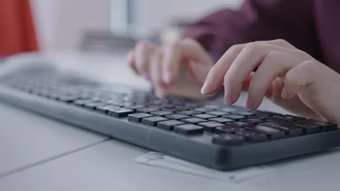 Close-up of a person's hands typing on a plastic gaming keyboard with multi Stock Footage 240328850