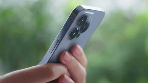 Close-up of person's hands typing on text on new phone, against background of Stock Footage 219620315