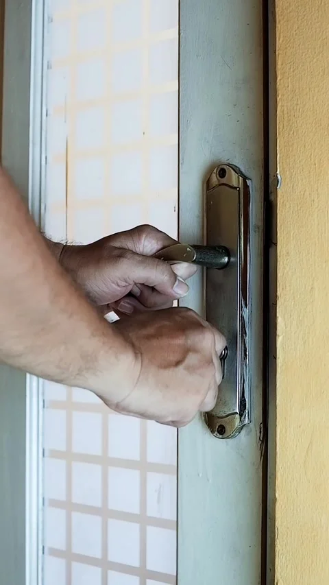 Close-up of a person’s hands unlocking and opening a door Stock Footage 320443374