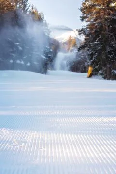 Close-up perspective of groomed ski run in the forest Stock Photos