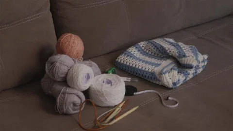 Close up perspective of knitting supplies and handmade garment Stock Footage 337452037