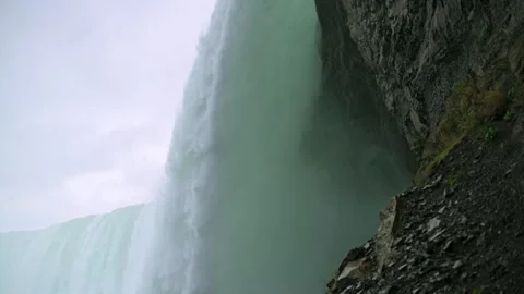 Close-up perspective of Niagara Falls, showing cascading water next to rugged Stockbeeldmateriaal 293122130