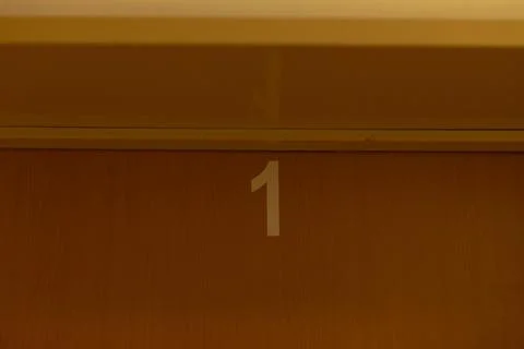 Close perspective of number one engraved or painted on wooden background Stock Photos