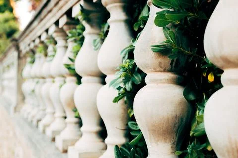 Close-up perspective of a row of carved stone balusters on a terrace railin.. Fotos Stock