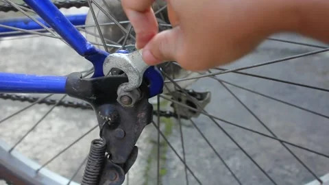Close up perspective shows a person's hand holding a small metal wrench Video stock 335026325