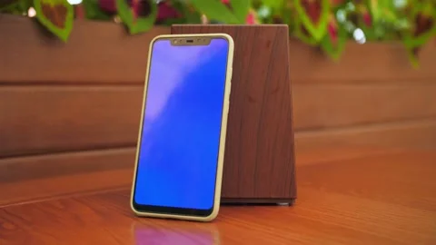 Close-up phone with a blue screen on the restaurant table.People use the pho Stock Footage 203509240