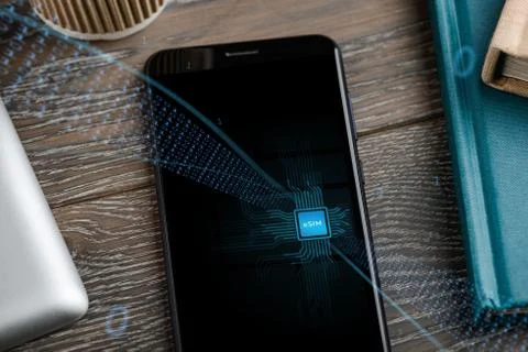 Close up on a phone that includes e-SIM. Data streams into the gadget Stock Photos