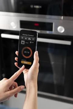 Close up phone with kitchen control Stock Photos