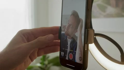 Close up on phone man pressing record button on screen filming vertical Stock Footage 316299494