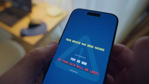 Close up on phone with message alert of ransom request from hacker group taking Stock Footage 344231567