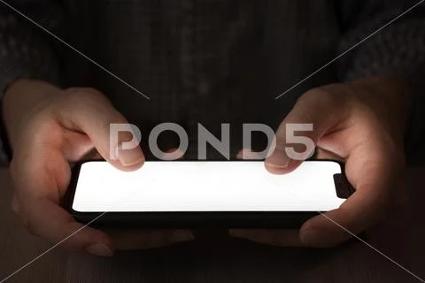 Close up phone, Person plays a mobile game at night, sits on social networks PSD Template