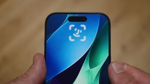 Close up on phone using facial recognition algorithm to unlock device for use Stock Footage 345518025