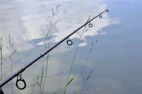 Close up photo of angling rod over the water Stock Photos