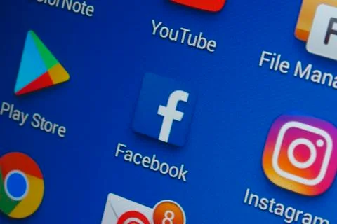 A close-up photo of Apple iPhone start screen with ‘Facebook' apps icon. Stock Photos