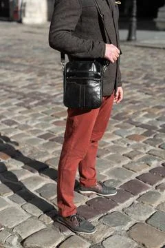 Close-up photo of black messanger leather bag on mans shoulder Stock Photos